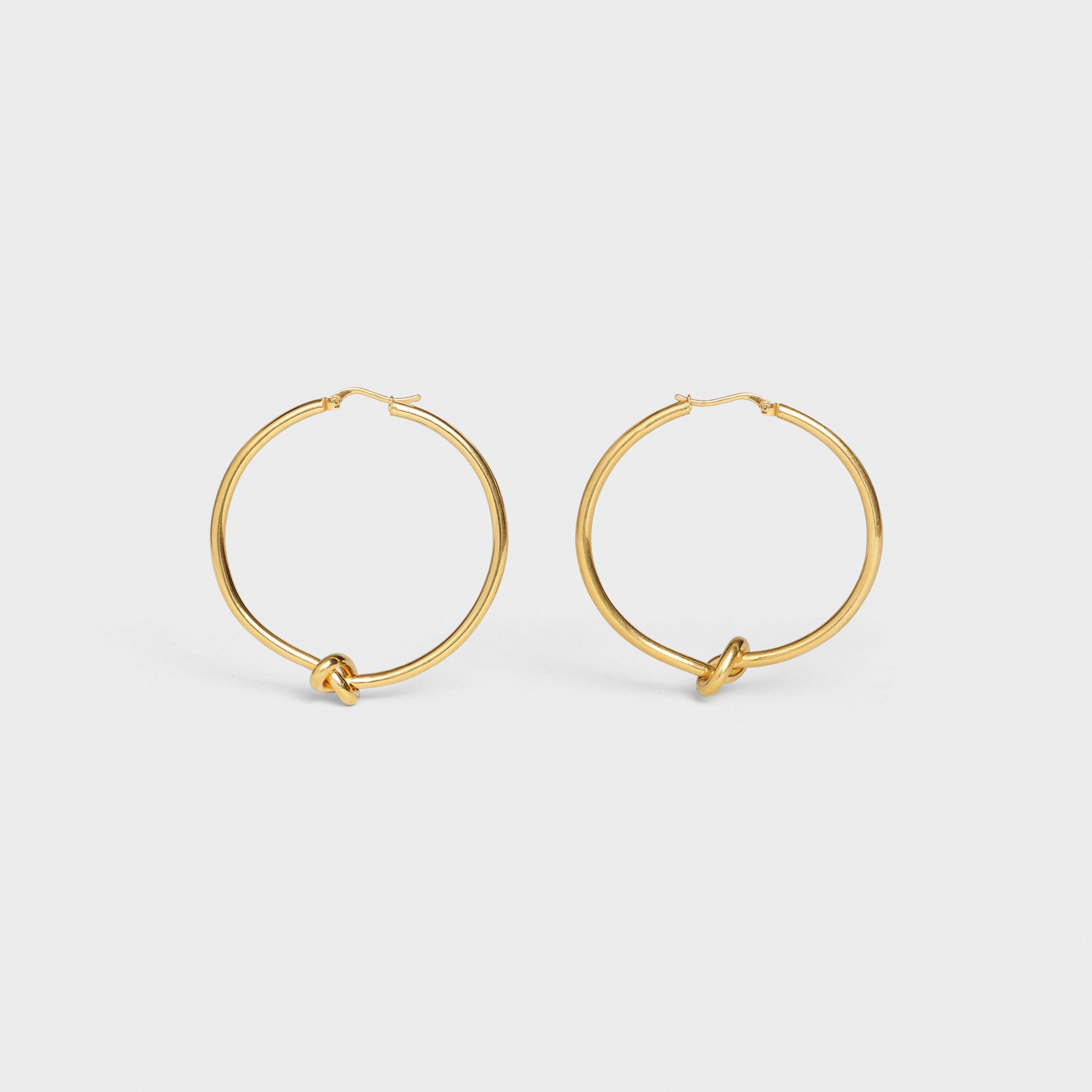 CÉLINE KNOT LARGE HOOPS IN BRASS WITH GOLD FINISH